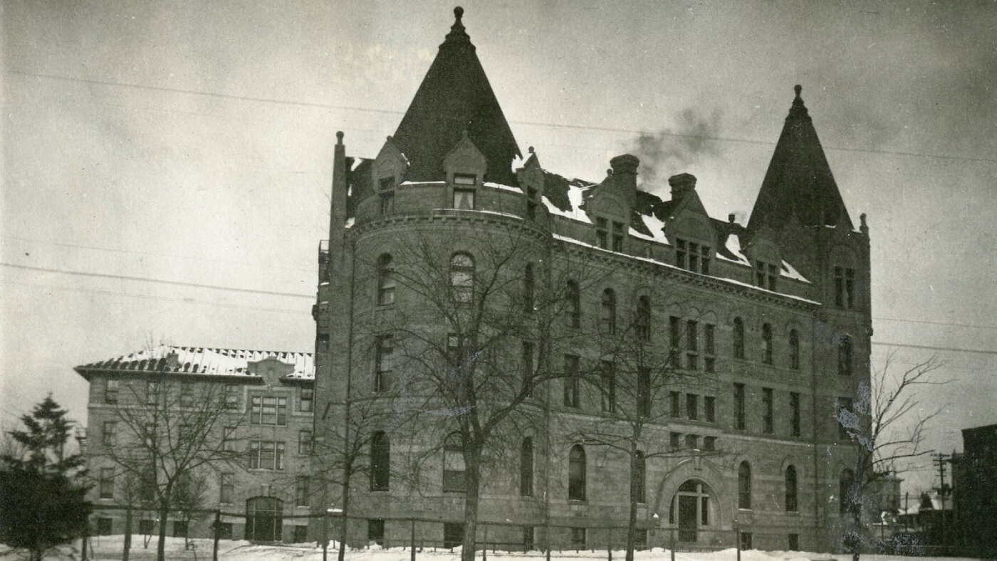 A black and white photograph of Wesley Hall in the snow