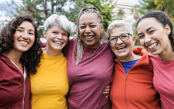 Group photo of five women in workout clothes smiling 