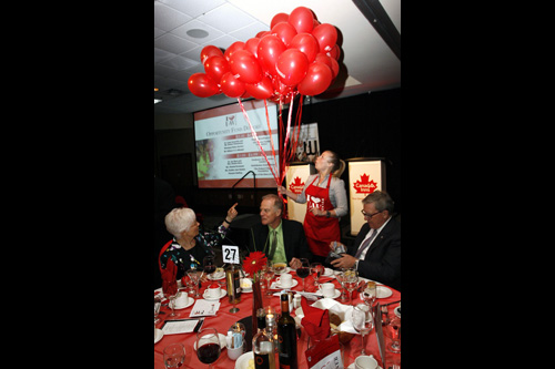 Attendees at table with balloons in background