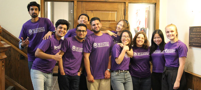 Ten student mentors wearing University of Winnipeg shirts in a group smiling