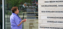 Elder looking at plaque on a building