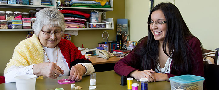 Two women beading