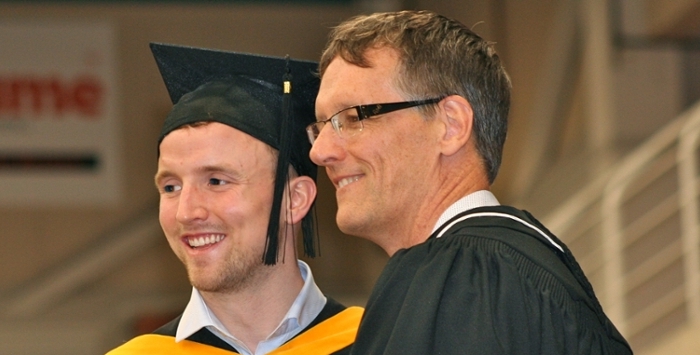 Graduation photo of Hartley Thwaites with Dr. James Currie, Acting Dean