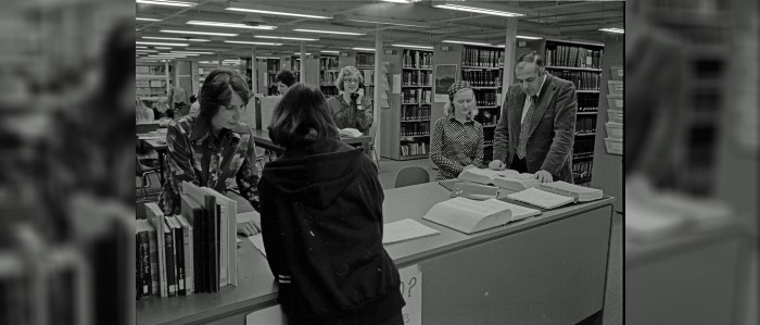 Black and white photo of busy library