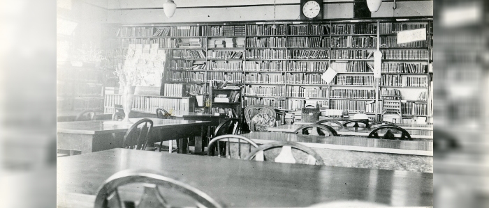 Black and white photo of tables and bookshelves inside Lower Wesley Hall in 1934