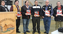 Individuals holding cookbook 