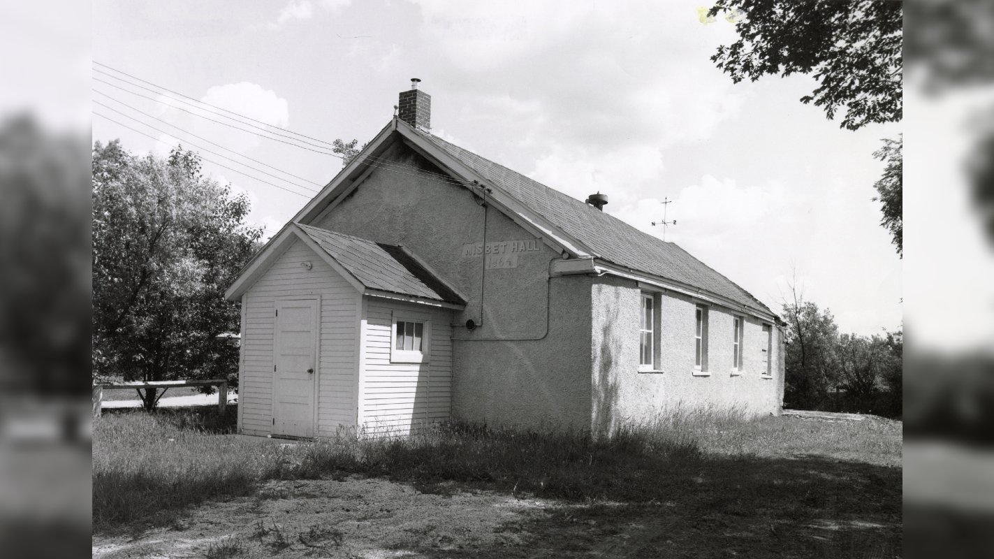 Black and white photo of building in a field 