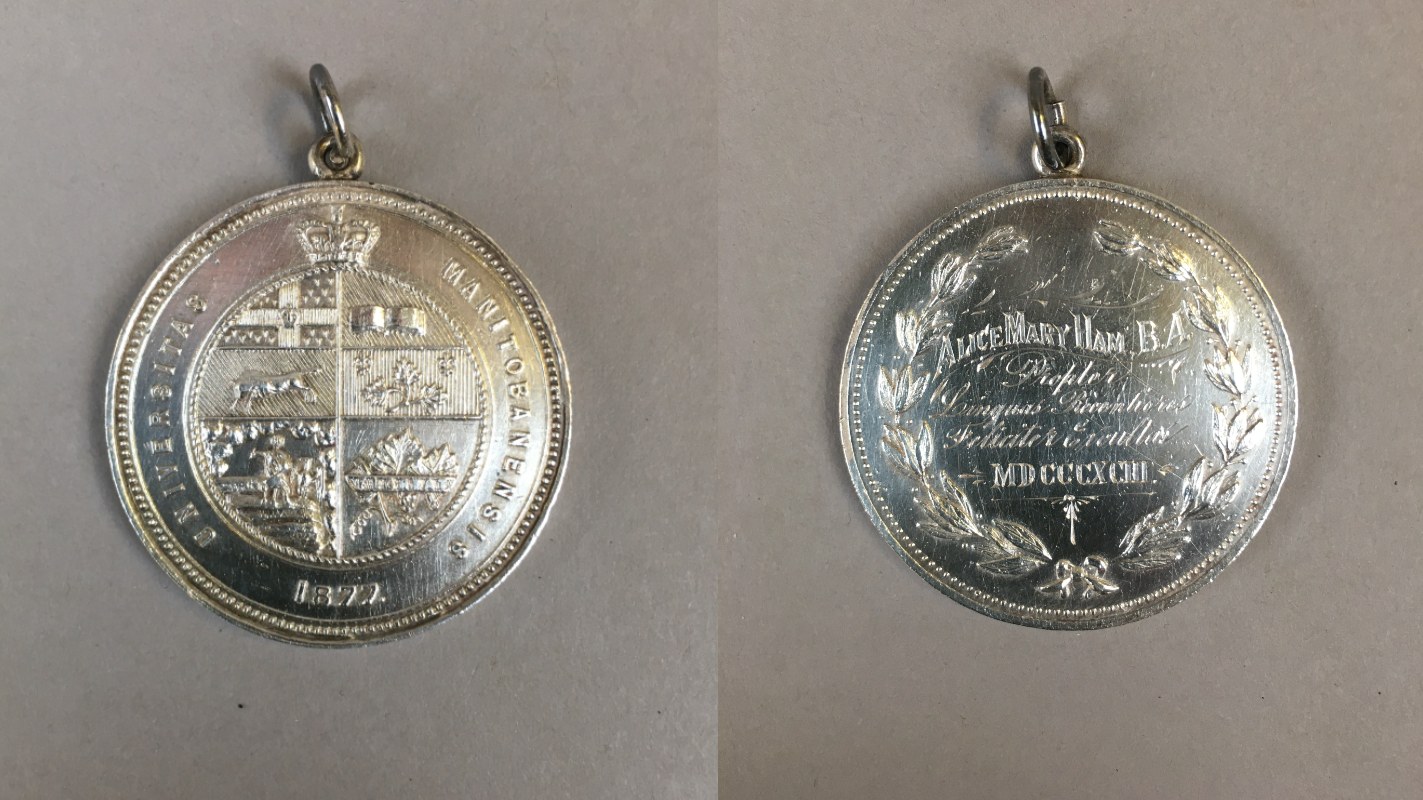 A silver medal bearing the Manitoba College crest and with Alice May's name engraved into the backside.