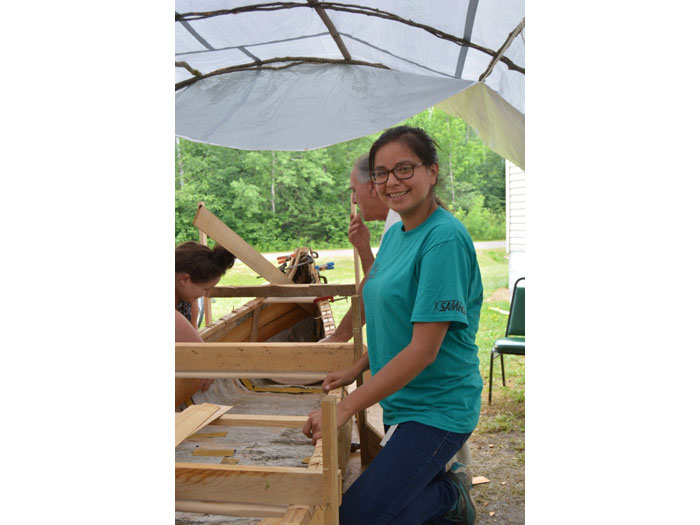 Inserting the cedar plank lining to the Wiigwasi-jiimaan with Kristen and Marvin.   