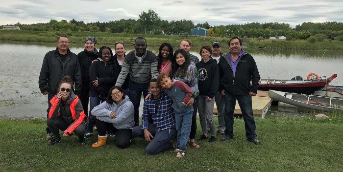 Group photo of students outdoors on the river bank