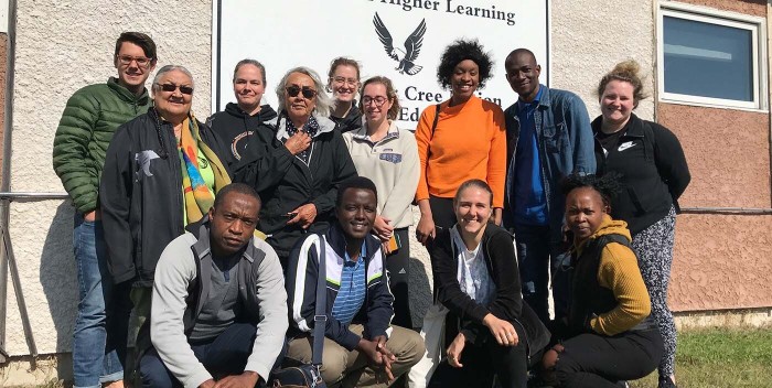 Group photo of students in front of a building a Fisher River