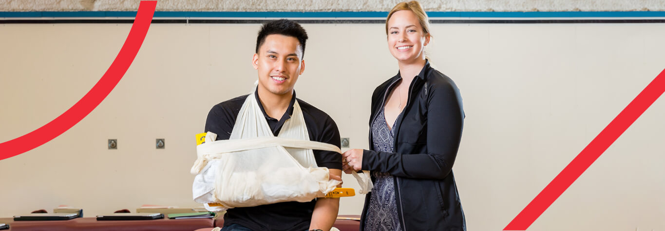 Two people, one in a cast, looking forward smiling