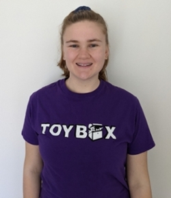 photo of Blatta, a blonde woman wearing a purple ToyBox t-shirt