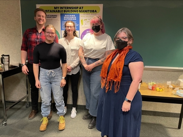 Dr. Patricia Fitzpatrick with four internship students, standing in front of a poster.