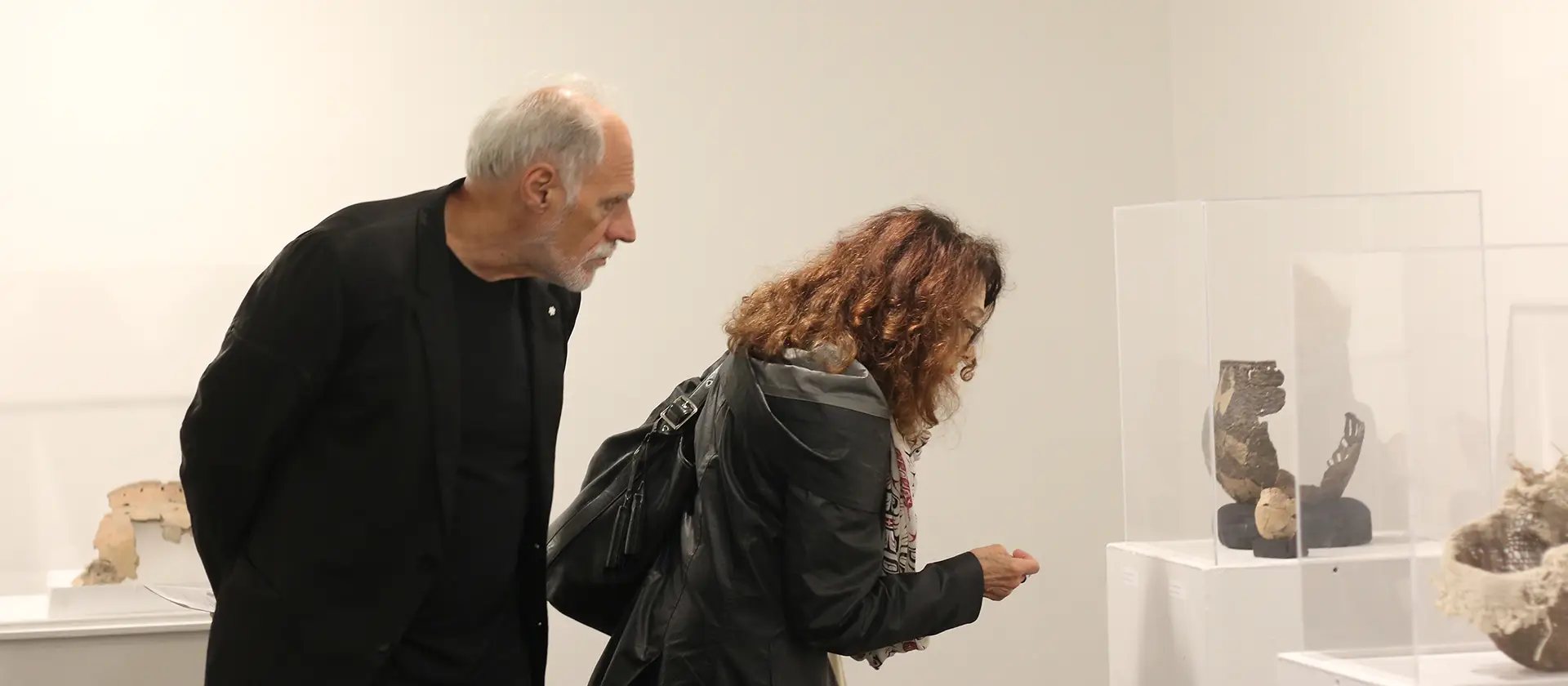 People in an art gallery looking at artifacts
