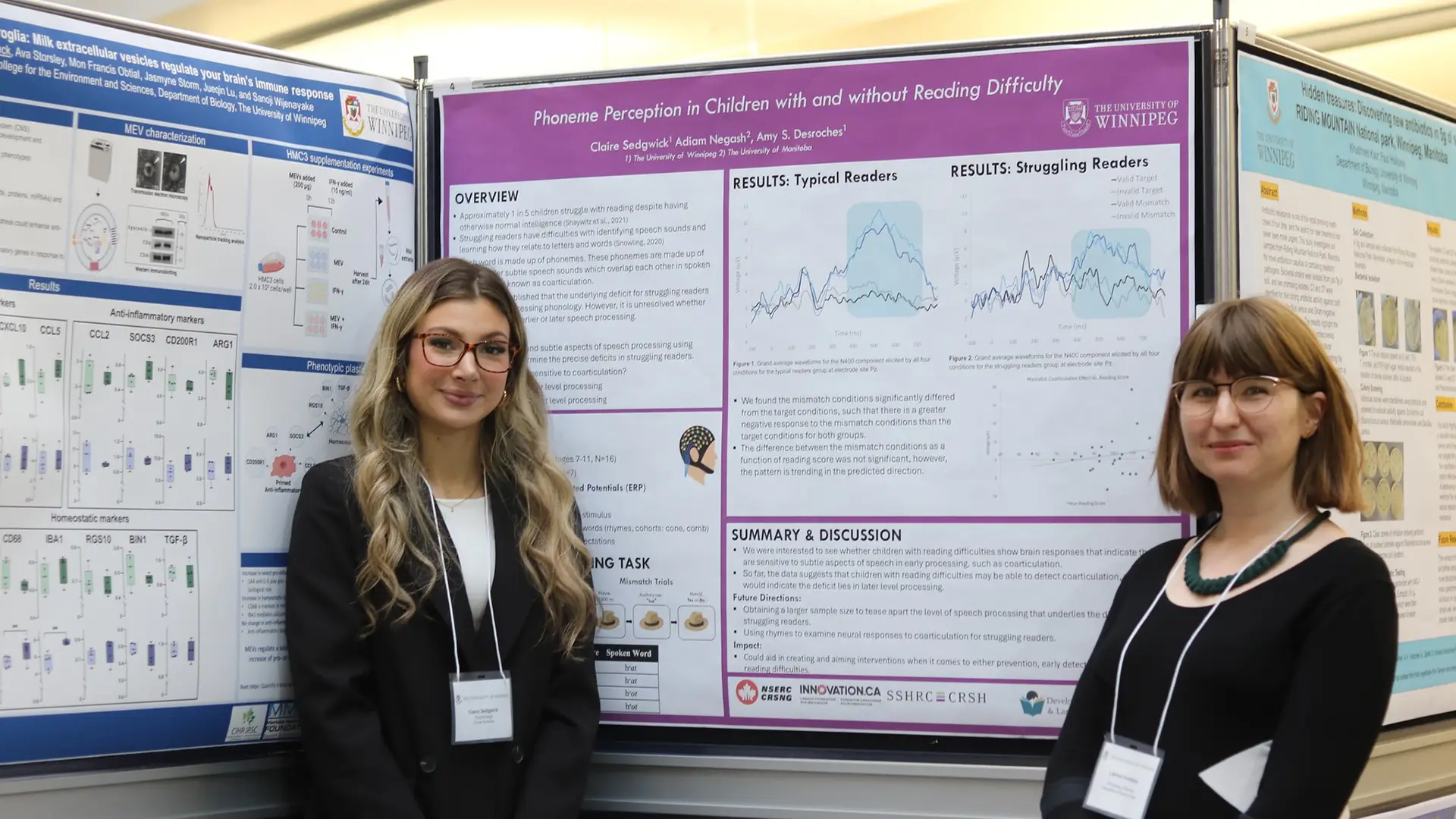 Two student standing in front of a poster at the symposium