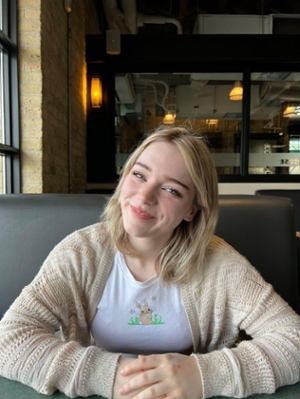 Jenna sitting with arms on table