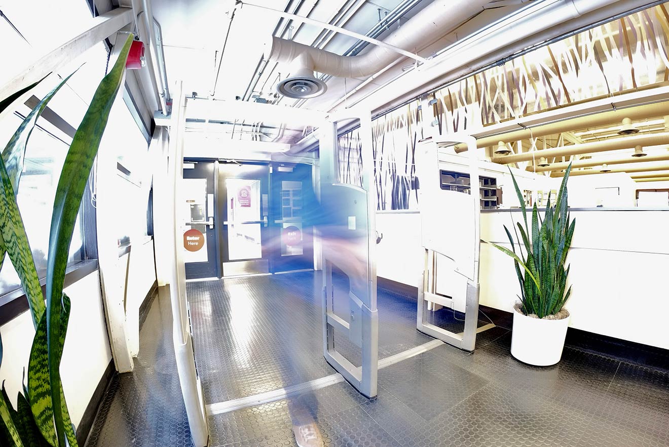 A motion-blur photo of a person coming in the Library's entrance.