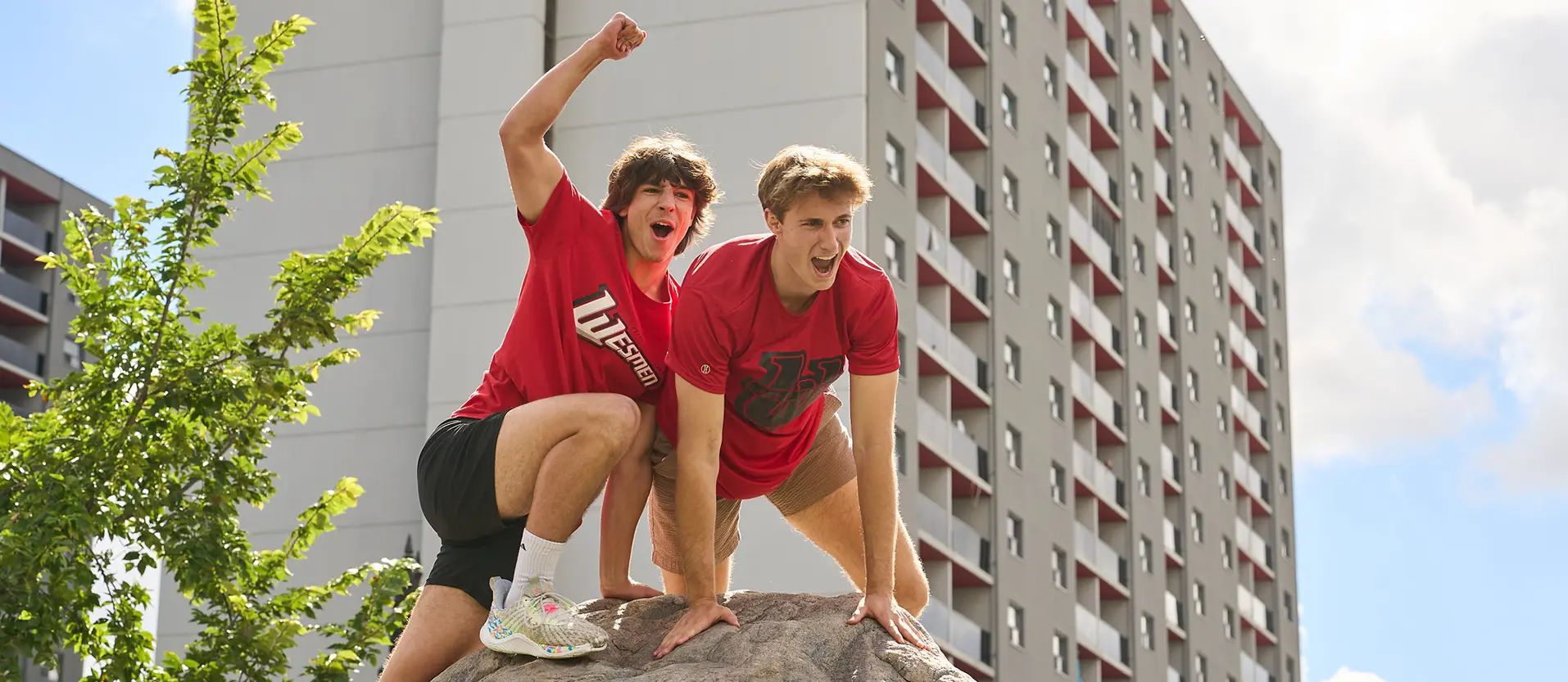 Two people celebrating at the top of the rock