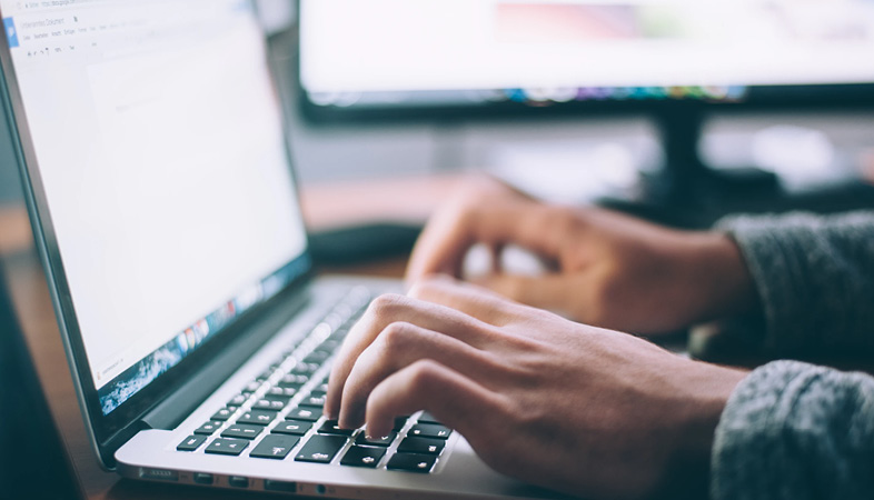 Hands on a laptop Keyboard