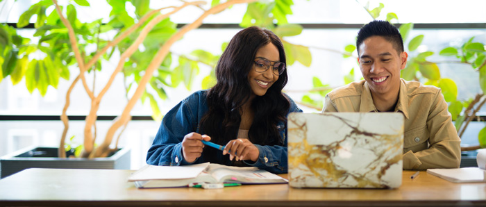 Two students looking at a laptop.