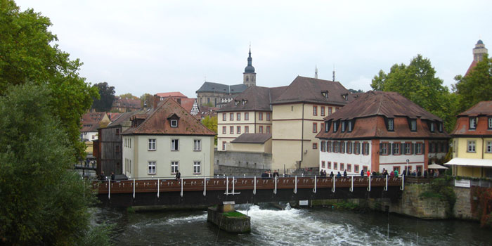 Outdoor scene bridge and rive with buildings in the background