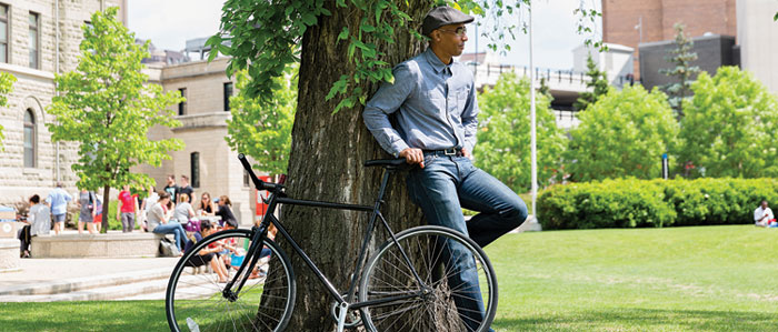 Man with bike on front lawn