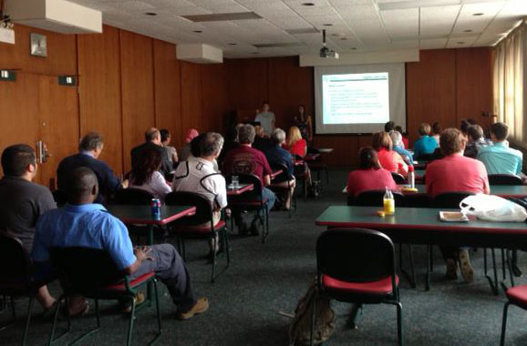 Room of people listening to presentation