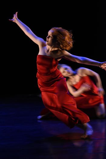 A dancer in red flies through the air