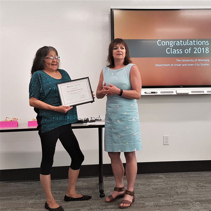 UIC Community Advocacy Grad May Henderson receiving her certificate