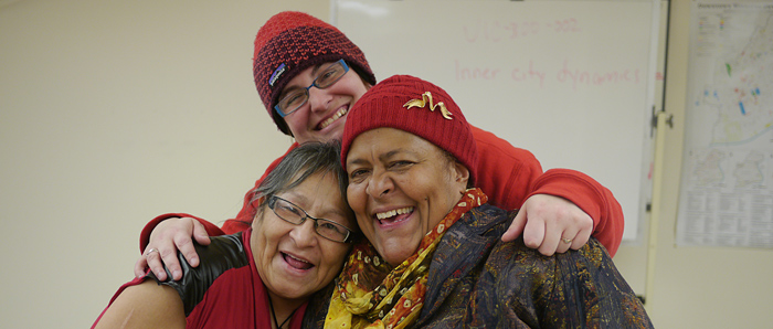 Group hug! Three UIC students lean on each other for support and some good laughs