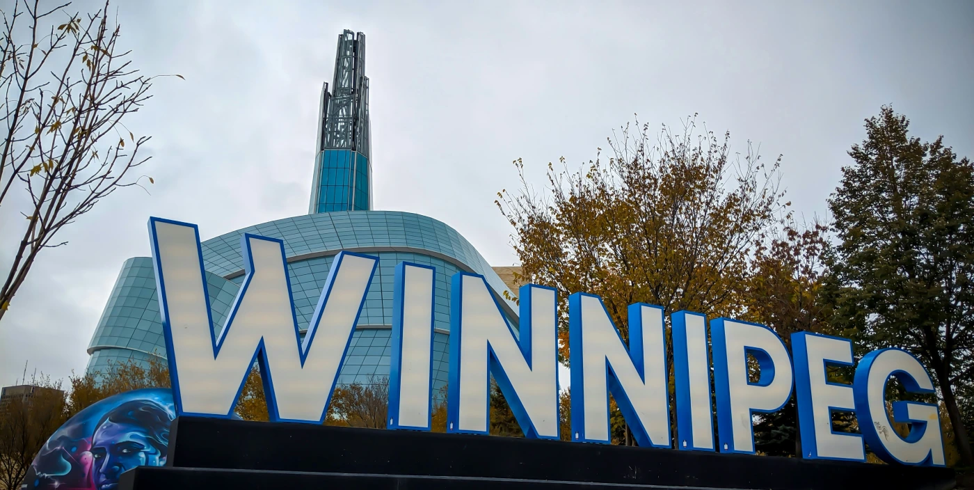 Canadian Museum of Human Rights behind the WINNIPEG sign at The Forks