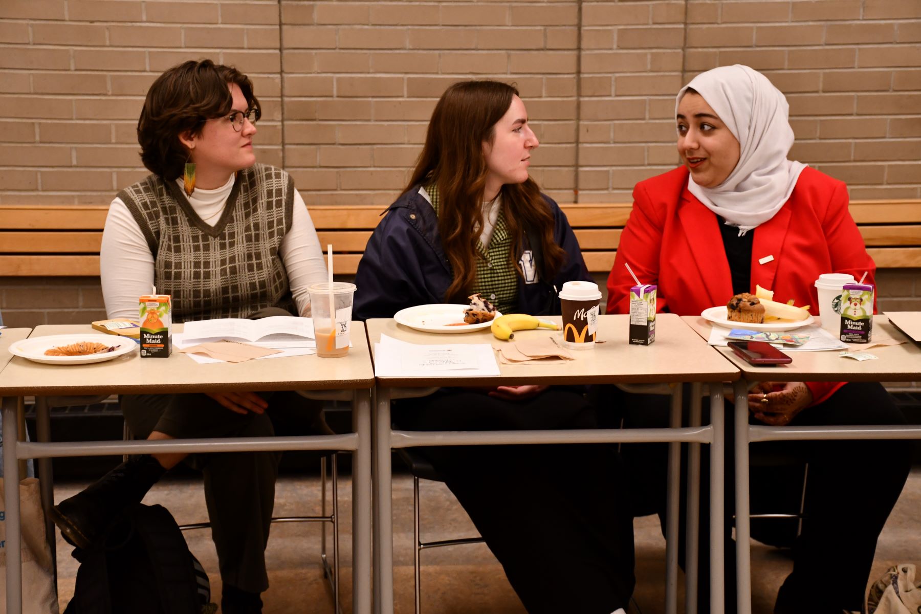 Taylor, Maddy, and Sondos chat during a break