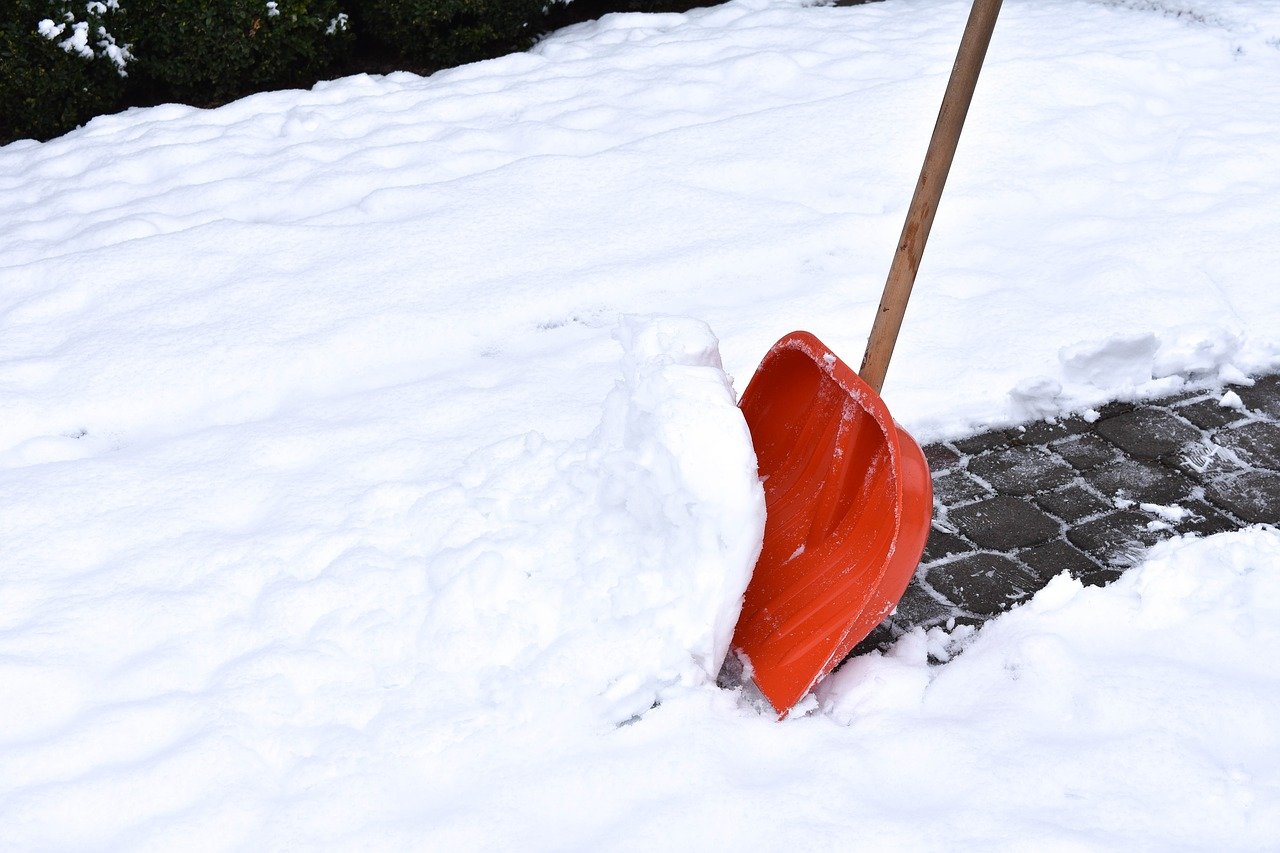 Red shovel being used on snow